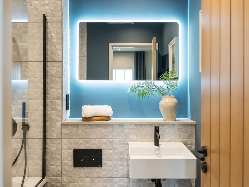 A bathroom with a washbasin and a shower at tbc in St. Ives