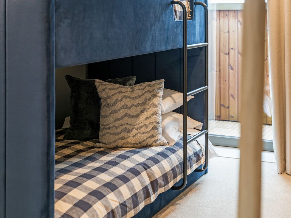 A bunk bed with pillows and sheets at tbc in St. Ives