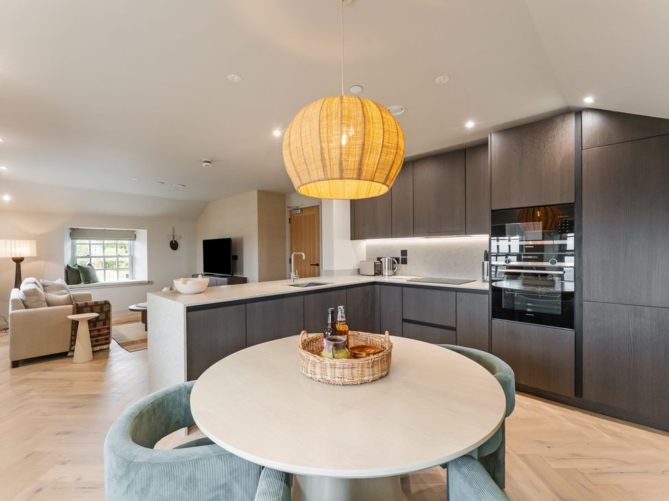 A kitchen with a round table and sofa area at tbc in St. Ives