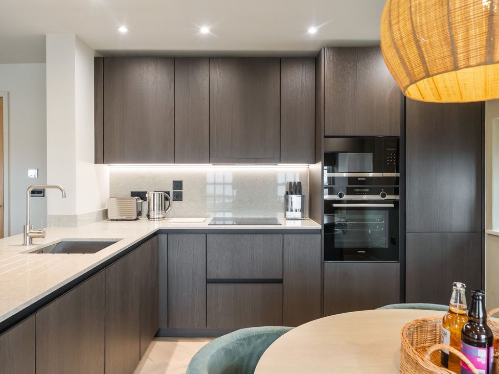 A kitchen with cabinets and appliances at tbc in St. Ives