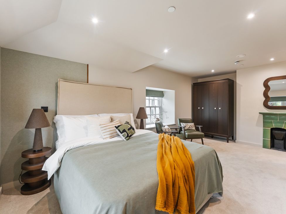 A bedroom with a bed and lamp at tbc in St. Ives