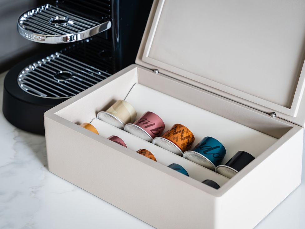 A coffee machine with a box of coffee capsules at Hidden 7- Coastal Loft in St Ives