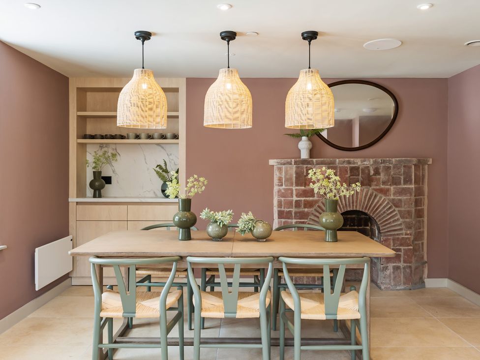 A dining room with a table and chairs at Hidden 7- Coastal Loft St Ives