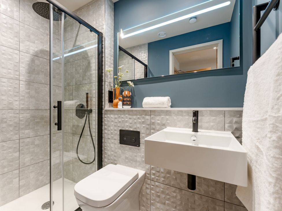 A bathroom with shower, toilet, and sink at tbc St. Ives