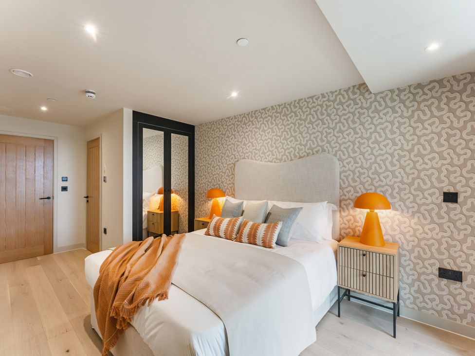 A bedroom with a bed and bedside table at tbc in St. Ives