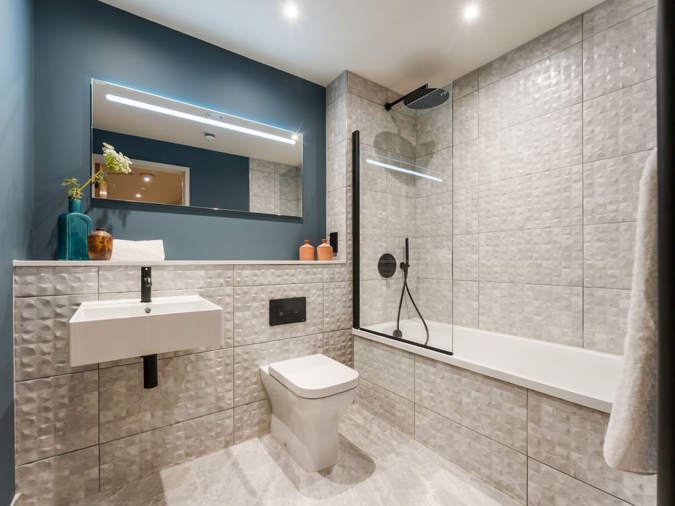 A bathroom with a bathtub and sink at tbc in St. Ives