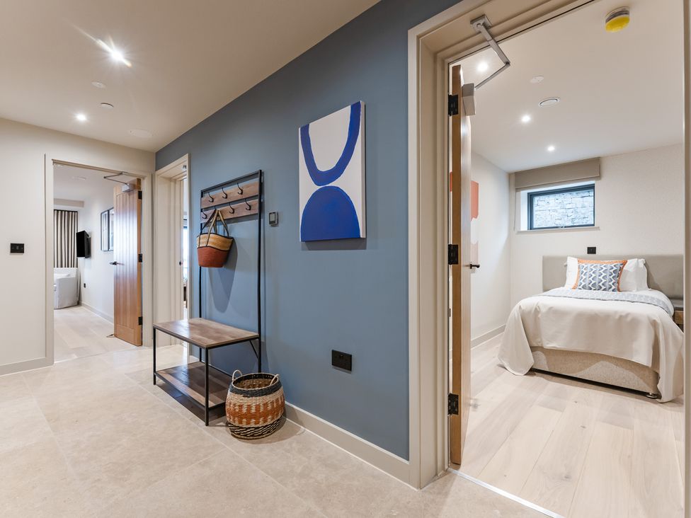 A hallway with a coat rack and connected rooms at tbc in St. Ives