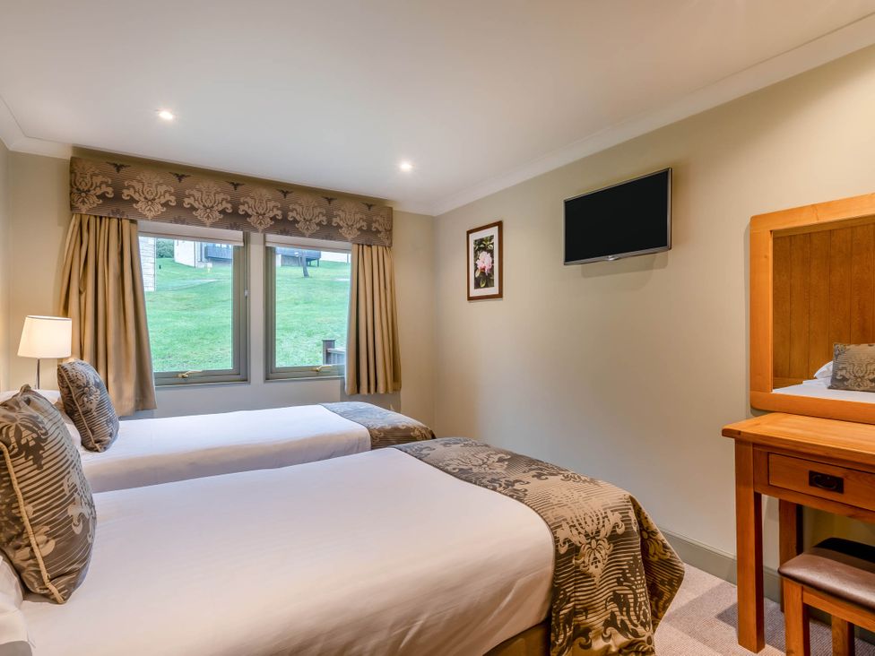 A bedroom with two beds and a television at The Derwent Spa (Pet) Slaley