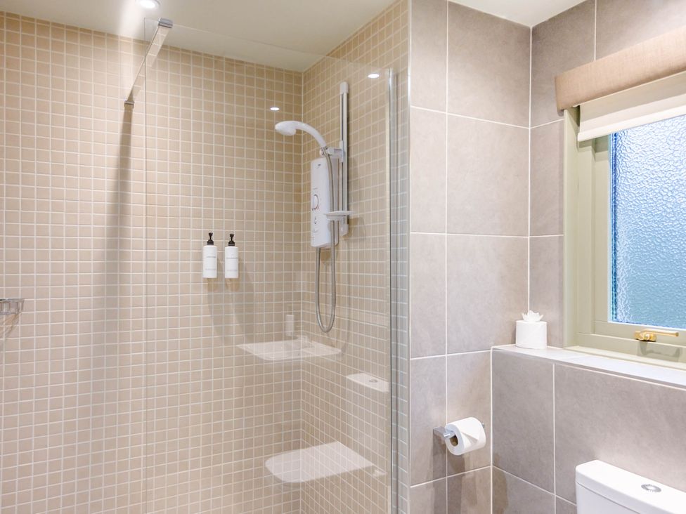 A bathroom with a shower and toiletries at The Derwent Spa (Pet) in Slaley
