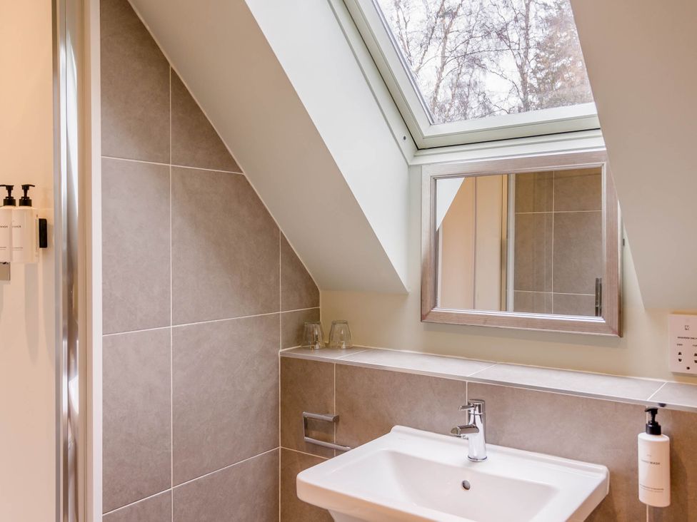A bathroom with a sink and mirror at The Derwent Spa (Pet) in Slaley