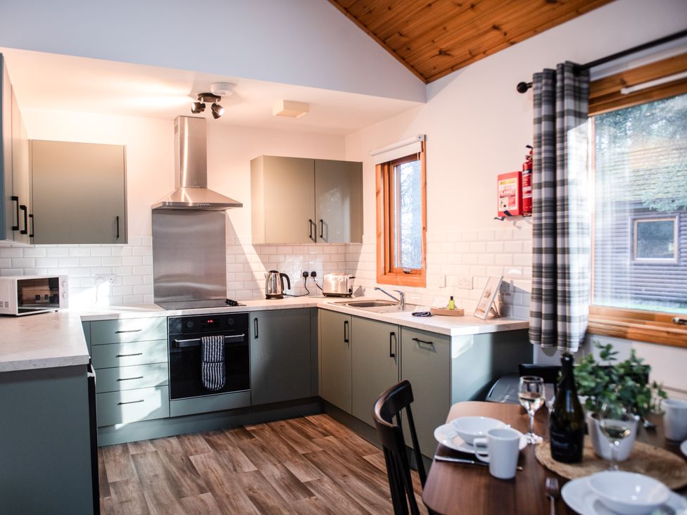 A kitchen with cabinets and appliances at Sidlaw Spa (Pet) Fowlis near Dundee