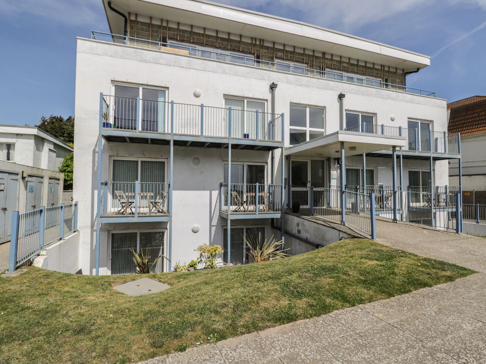 A building with balconies and a lawn at 7 Blue Water Bournemouth