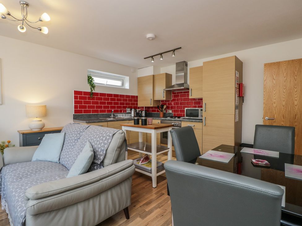A kitchen with a dining table and chairs at 7 Blue Water in Bournemouth