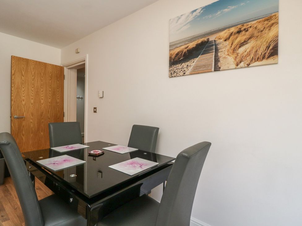 A dining room with a table and chairs at 7 Blue Water Bournemouth