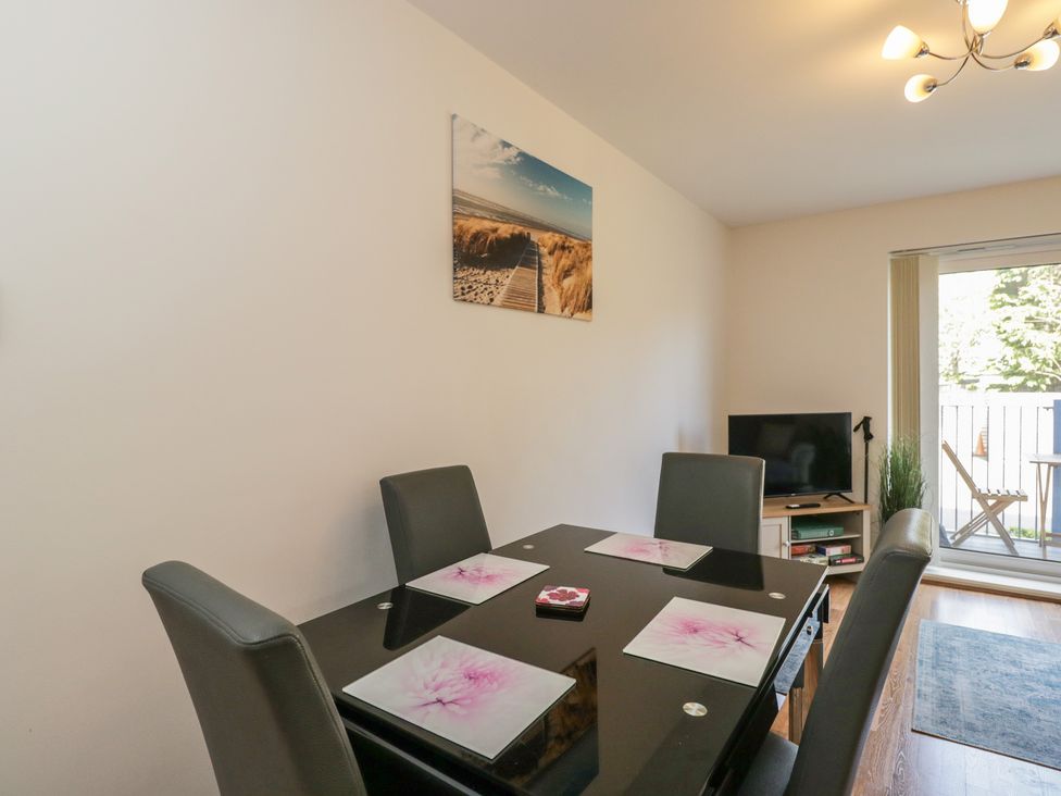 A dining room with a table and chairs at 7 Blue Water Bournemouth