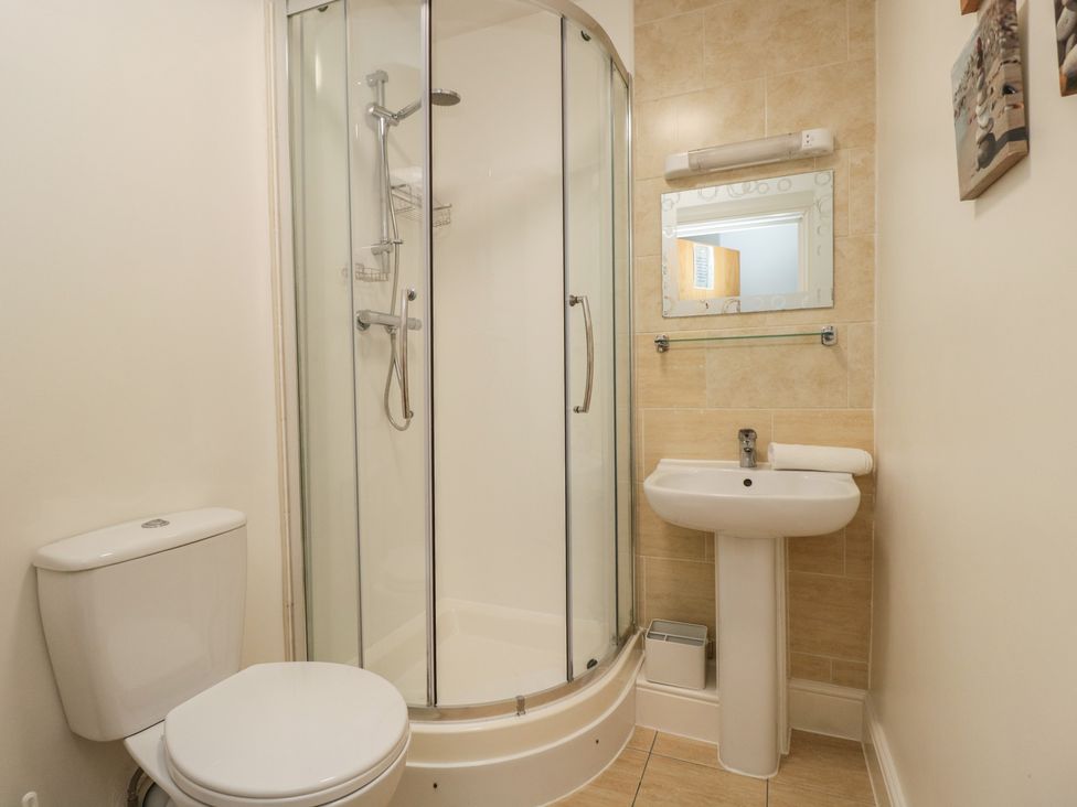 A bathroom with a shower, sink, and toilet at 7 Blue Water Bournemouth