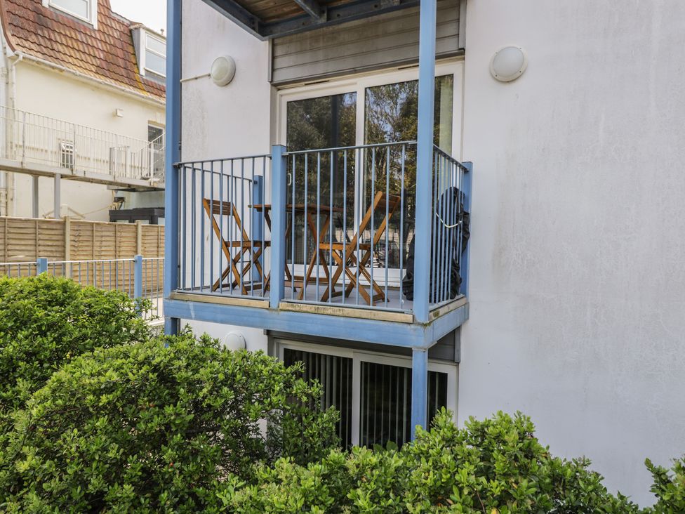 A balcony with chairs and a table at 7 Blue Water in Bournemouth