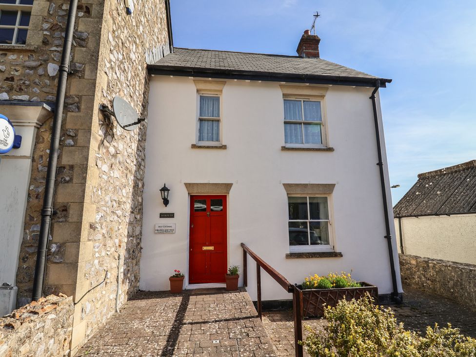 A house with a red door and windows at Morpeth in Combe St Nicholas