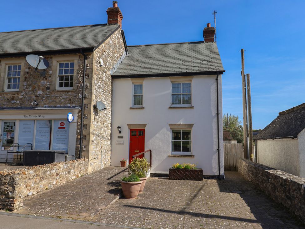 A house with a red front door and a flower pot at Morpeth in Combe St Nicholas