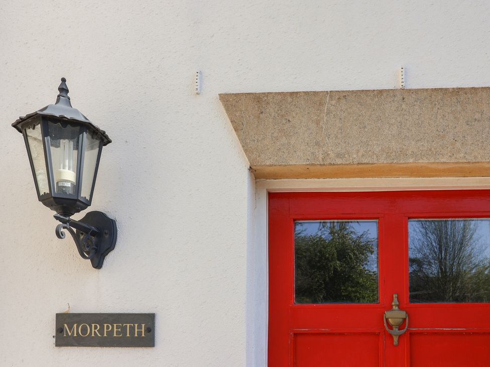A door with a lamp and nameplate at Morpeth in Combe St Nicholas