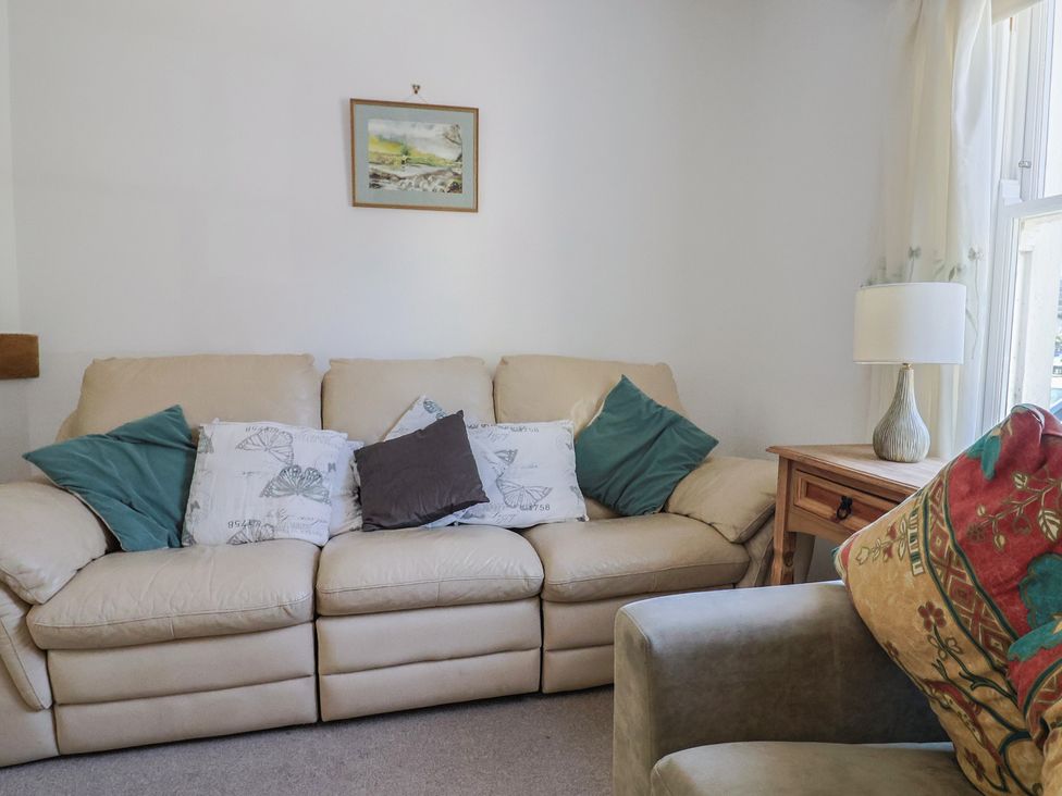A living room with a sofa and cushions at Morpeth in Combe St Nicholas