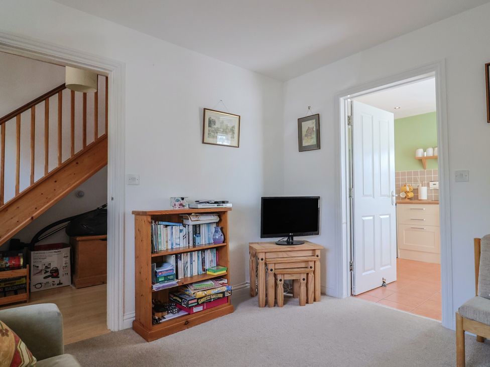 A living room with a bookshelf and television at Morpeth in Combe St Nicholas
