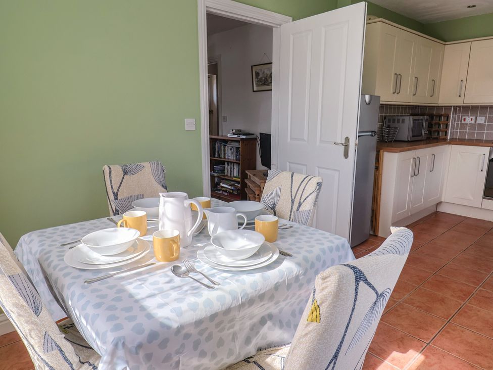 A dining room with a table set for meals at Morpeth in Combe St Nicholas