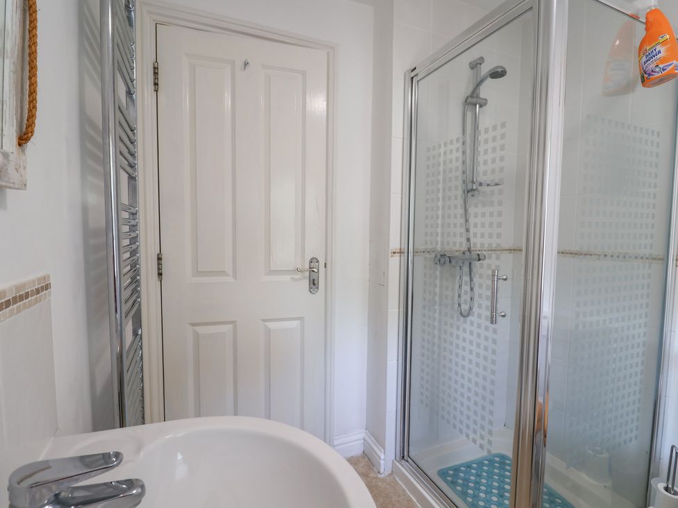 A bathroom with a bathtub and a shower enclosure at Morpeth in Combe St Nicholas