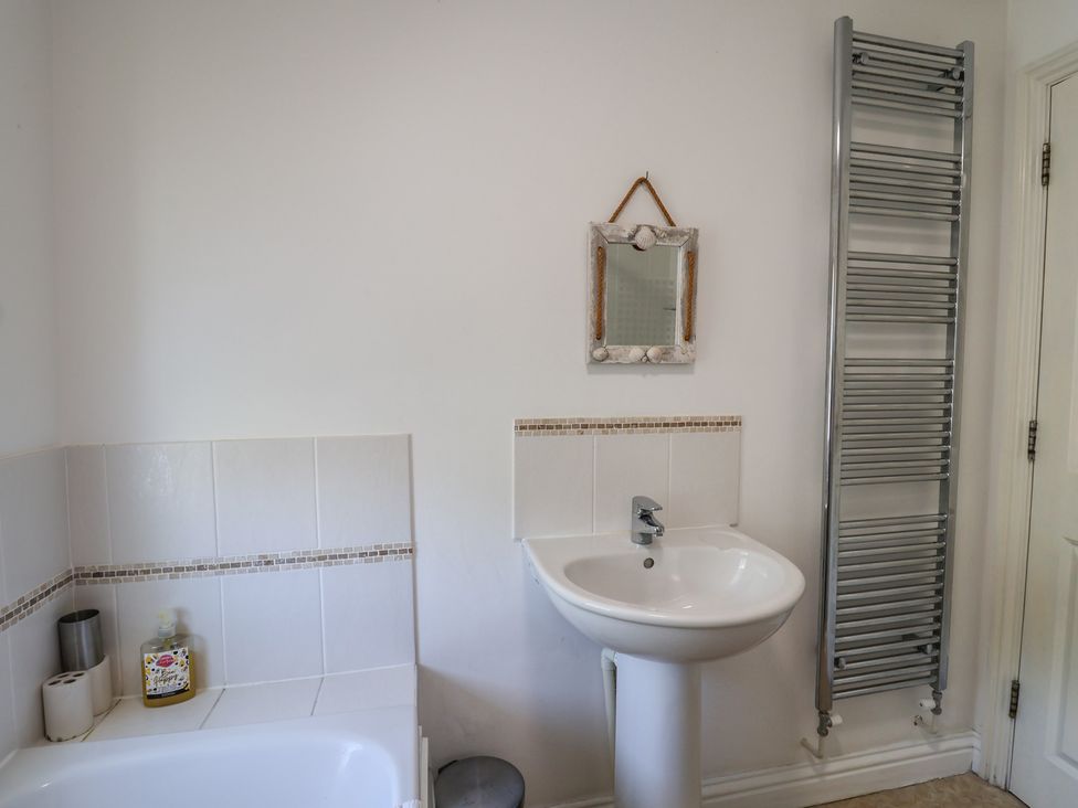A bathroom with a bathtub and sink at Morpeth in Combe St Nicholas