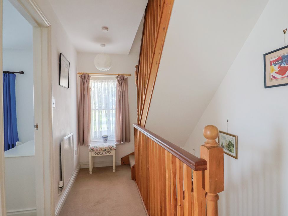 A hallway with a staircase and window at Morpeth in Combe St Nicholas