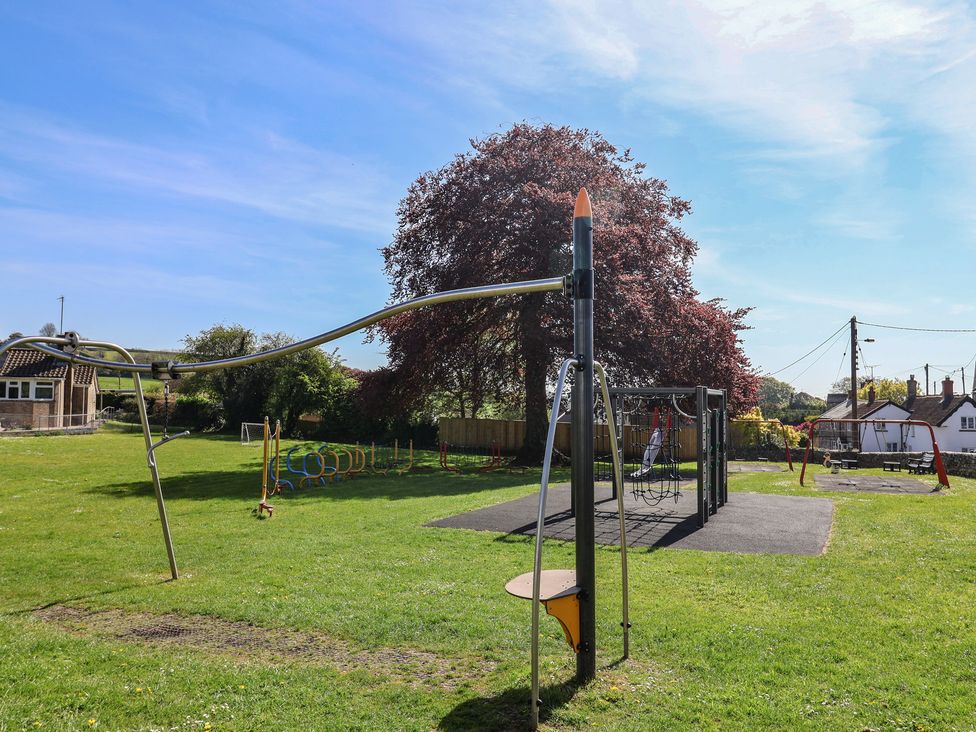 A playground with swings and climbing frame at Morpeth in Combe St Nicholas