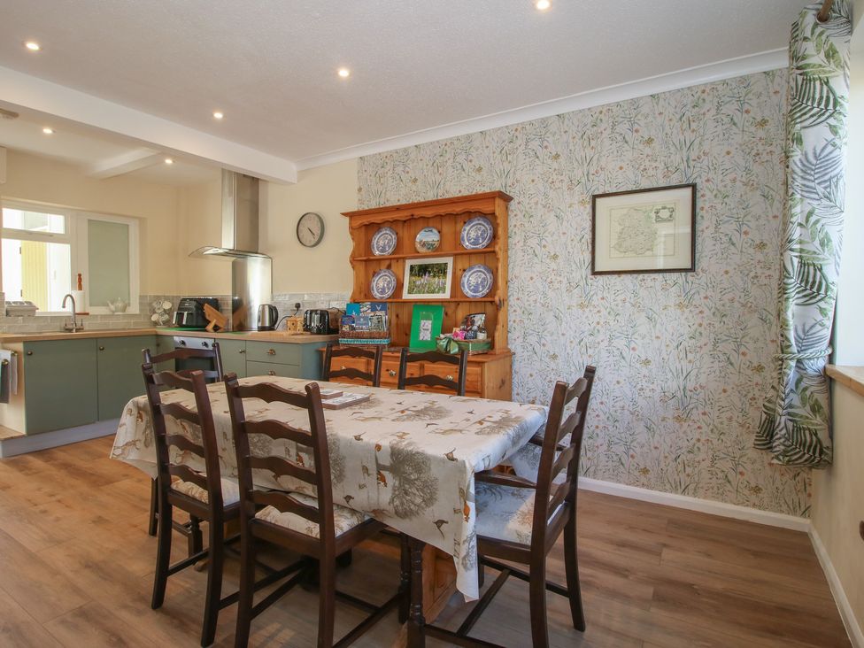 A kitchen with a dining table and chairs at Onny Views in Craven Arms