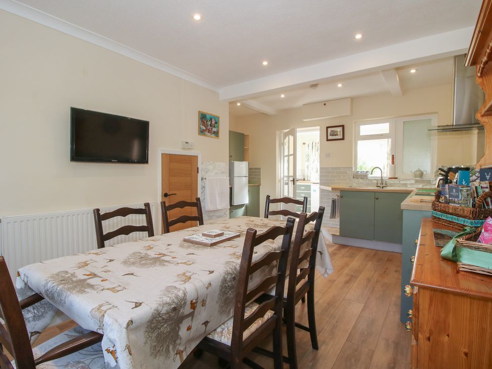 A kitchen with a dining table and television at Onny Views in Craven Arms