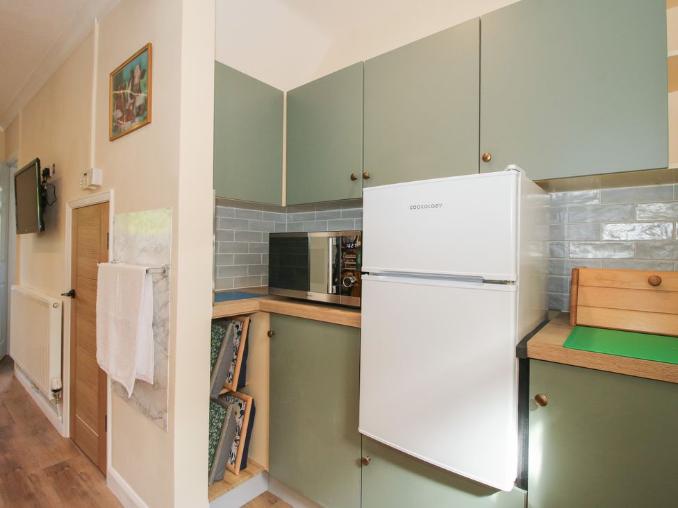 A kitchen with a fridge and microwave at Onny Views in Craven Arms