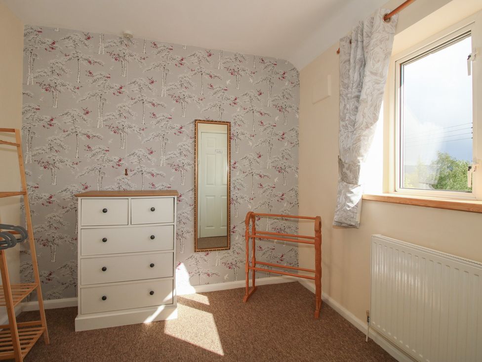 A bedroom with a chest of drawers and a mirror at Onny Views in Craven Arms