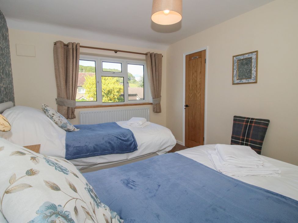 A bedroom with two beds and a window at Onny Views in Craven Arms
