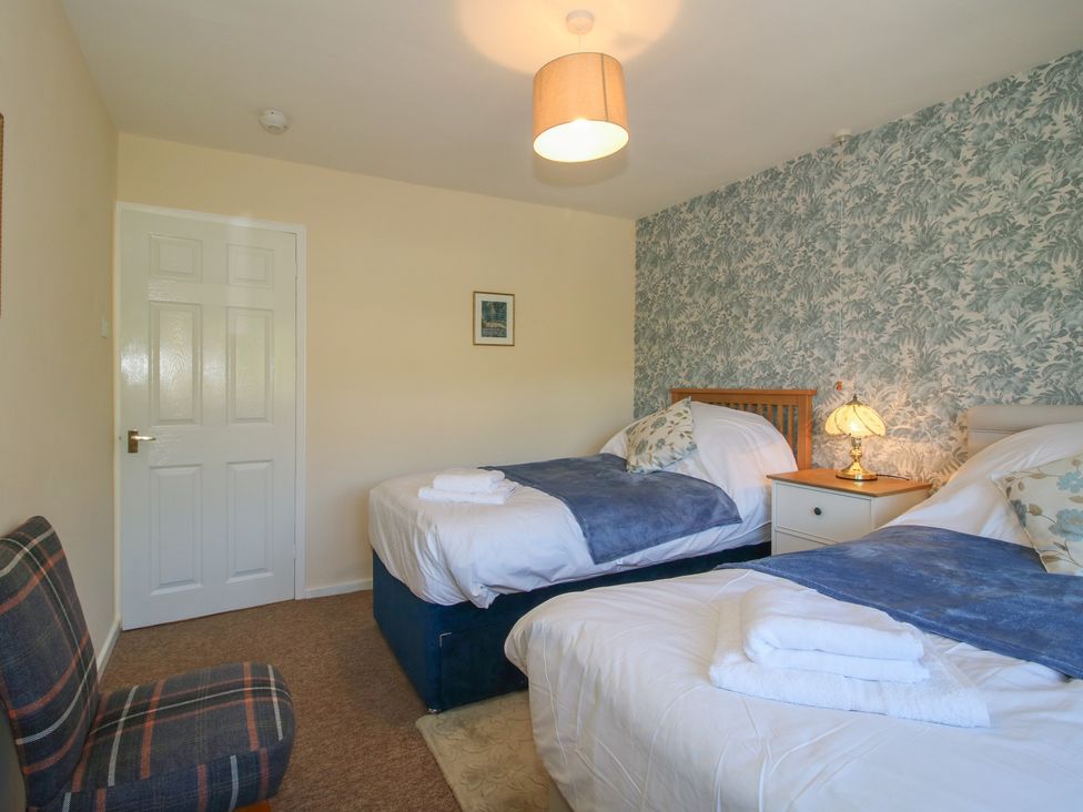 A bedroom with two beds and a lamp at Onny Views in Craven Arms