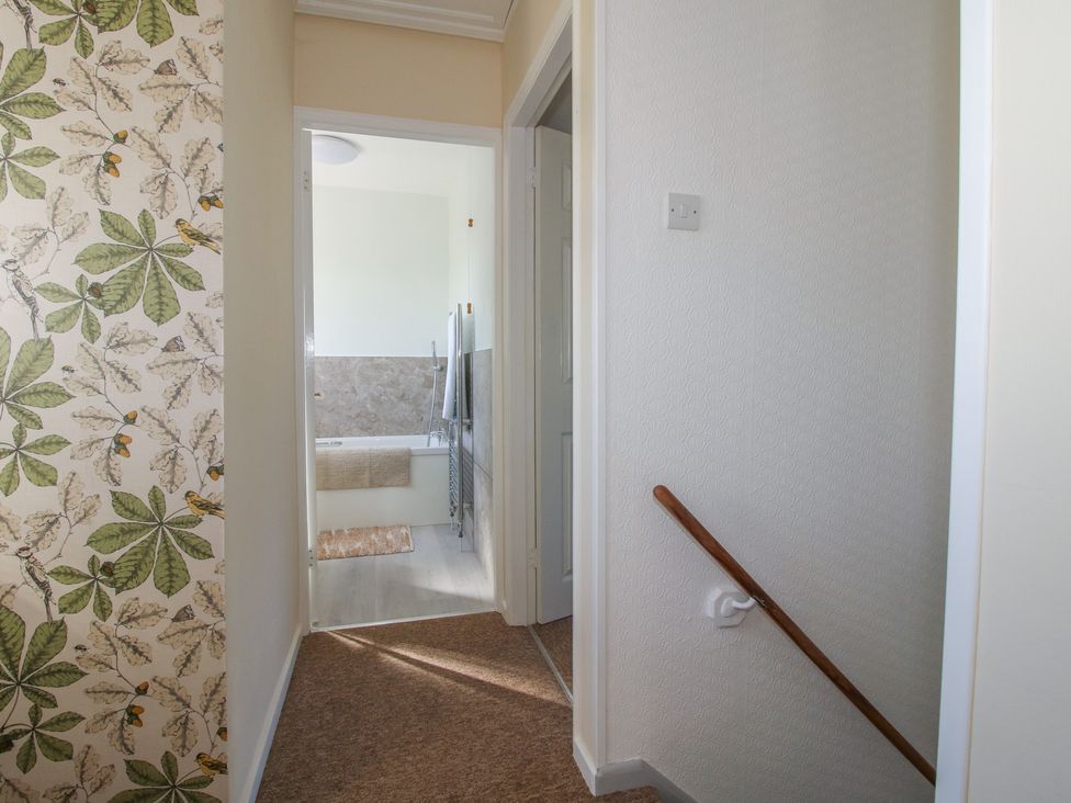 A hallway with doors leading to a bathroom at Onny Views in Craven Arms