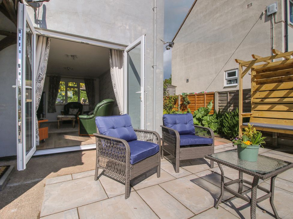 A garden with outdoor seating and a table at Onny Views in Craven Arms
