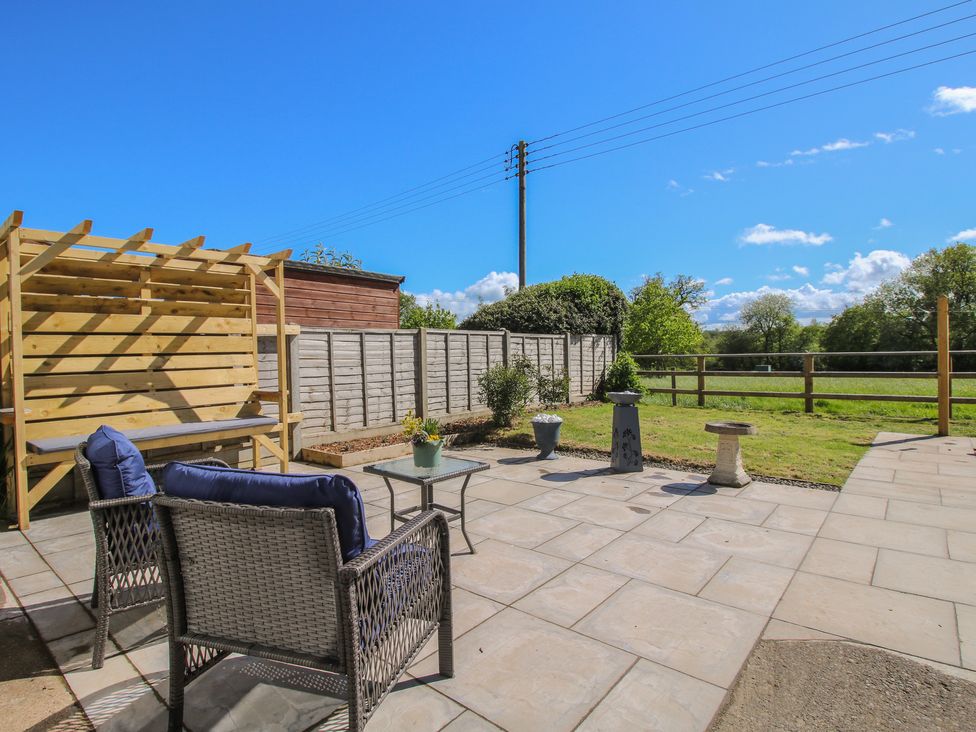 A garden with seating and a bench at Onny Views in Craven Arms