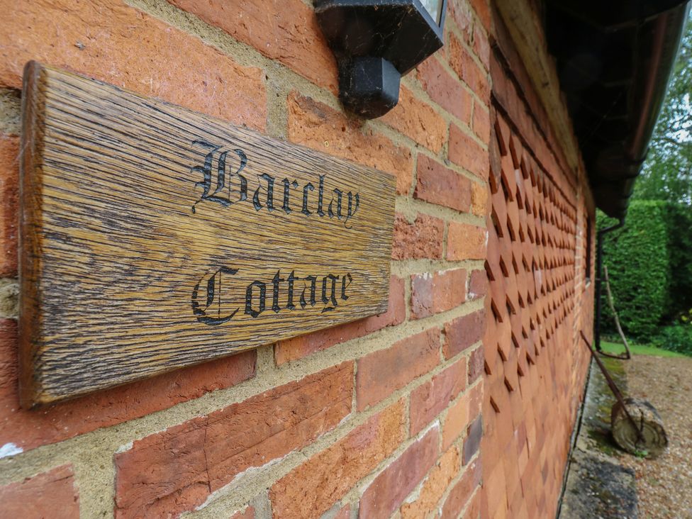 A sign that reads Barclay Cottage on a brick wall at Barclay Cottage in Biddenden