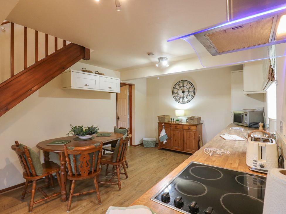 A kitchen with a dining table and chairs at Barclay Cottage in Biddenden
