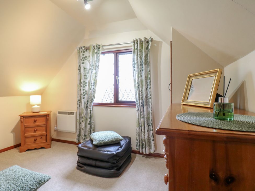 A bedroom with furniture and window at Barclay Cottage in Biddenden