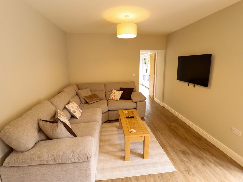 A living room with a sofa and a coffee table at Bobblehat Barn in Alford