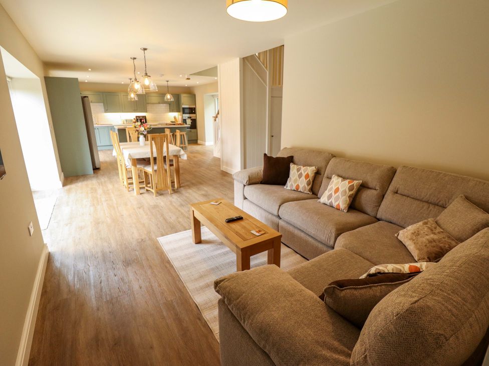 A living room with a sofa and coffee table at Bobblehat Barn in Alford