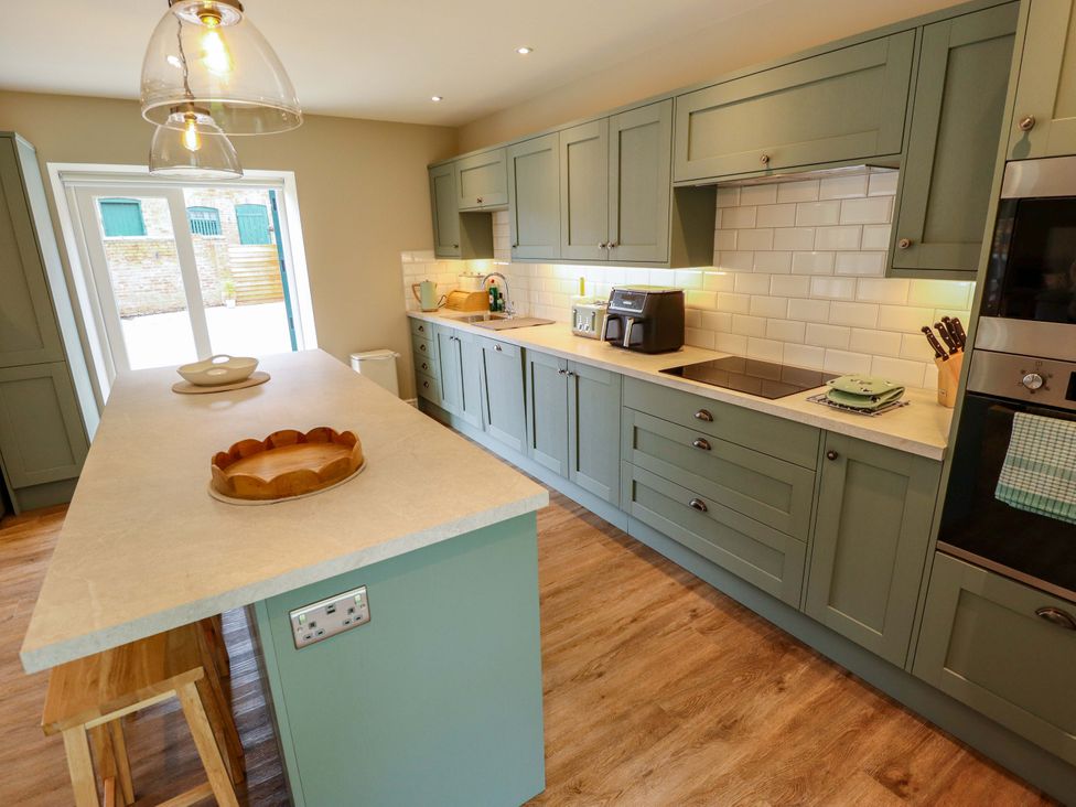 A kitchen with cabinets and appliances at Bobblehat Barn Alford