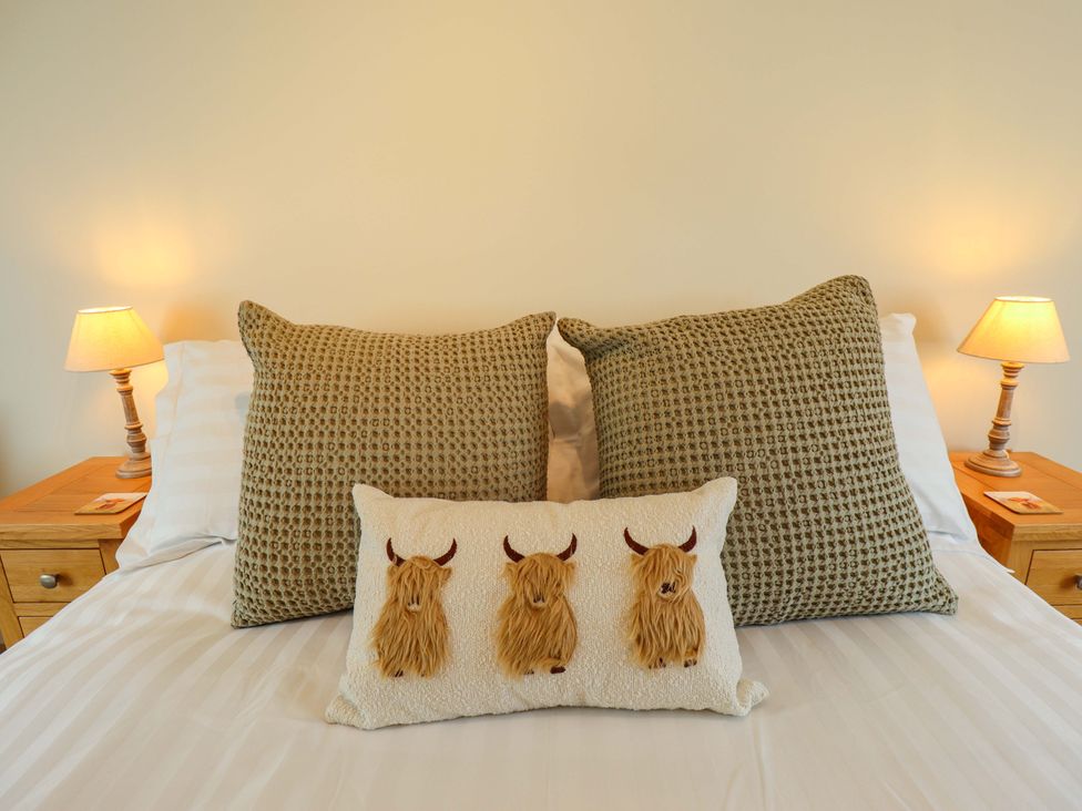 A bedroom with a bed and pillows at Bobblehat Barn Alford