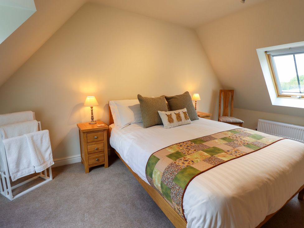 A bedroom with a bed and bedside table at Bobblehat Barn in Alford