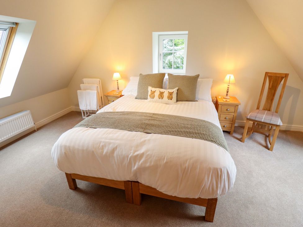 A bedroom with a bed and nightstand at Bobblehat Barn in Alford