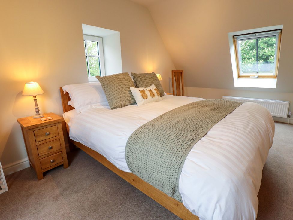 A bedroom with a bed and bedside table at Bobblehat Barn in Alford